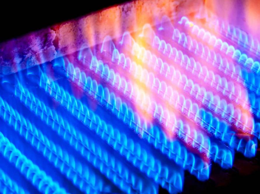 Fire burns from a gas burner inside the boiler